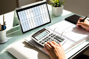 Calculator and laptop at desk